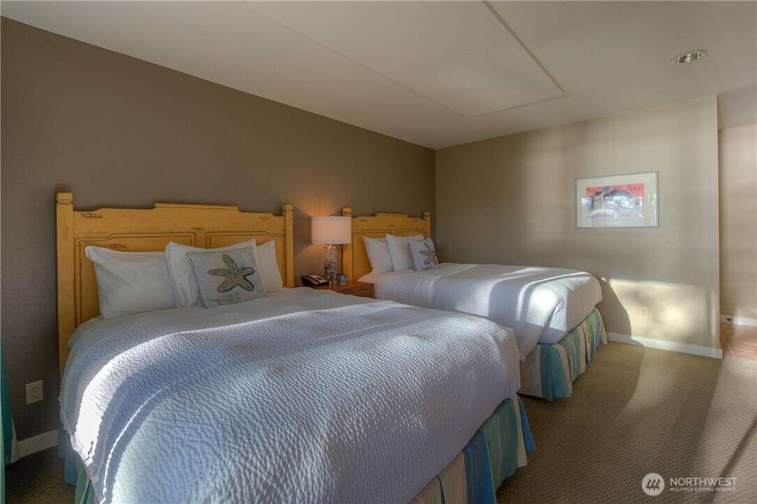 1917 Rosario Road, Unit 2104 Orcas Island, WA 98245 - Photo 23 of 28 a bedroom with a bed and a painting on the wall