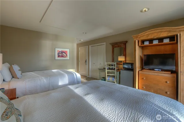 a bedroom with a large bed and a tv