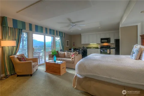 a bedroom with a large bed and a couch