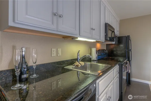 a kitchen with a sink and cabinets