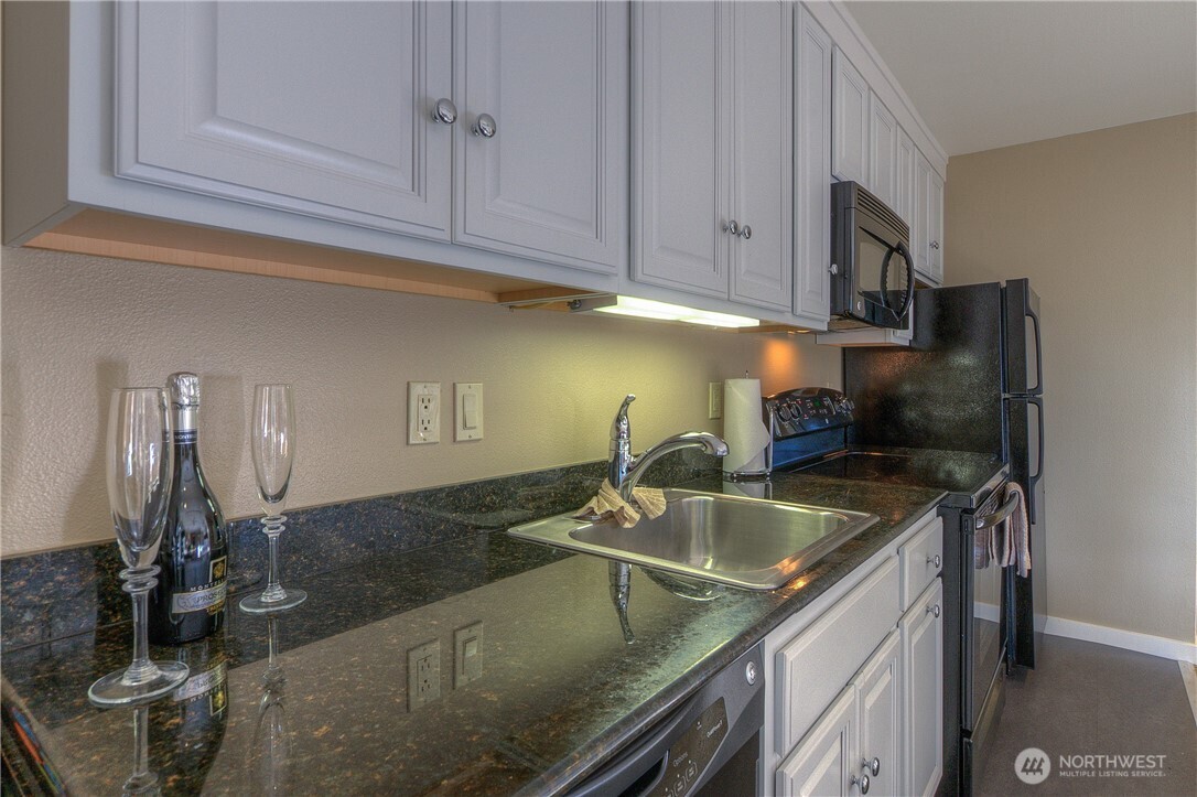 1917 Rosario Road, Unit 2104 Orcas Island, WA 98245 - Photo 8 of 28 a kitchen with a sink and cabinets