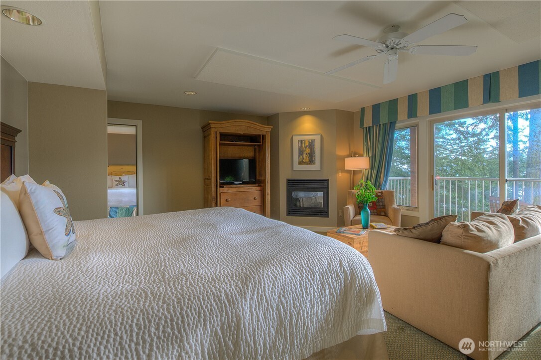 1917 Rosario Road, Unit 2104 Orcas Island, WA 98245 - Photo 10 of 28 a bedroom with a bed and glass windows