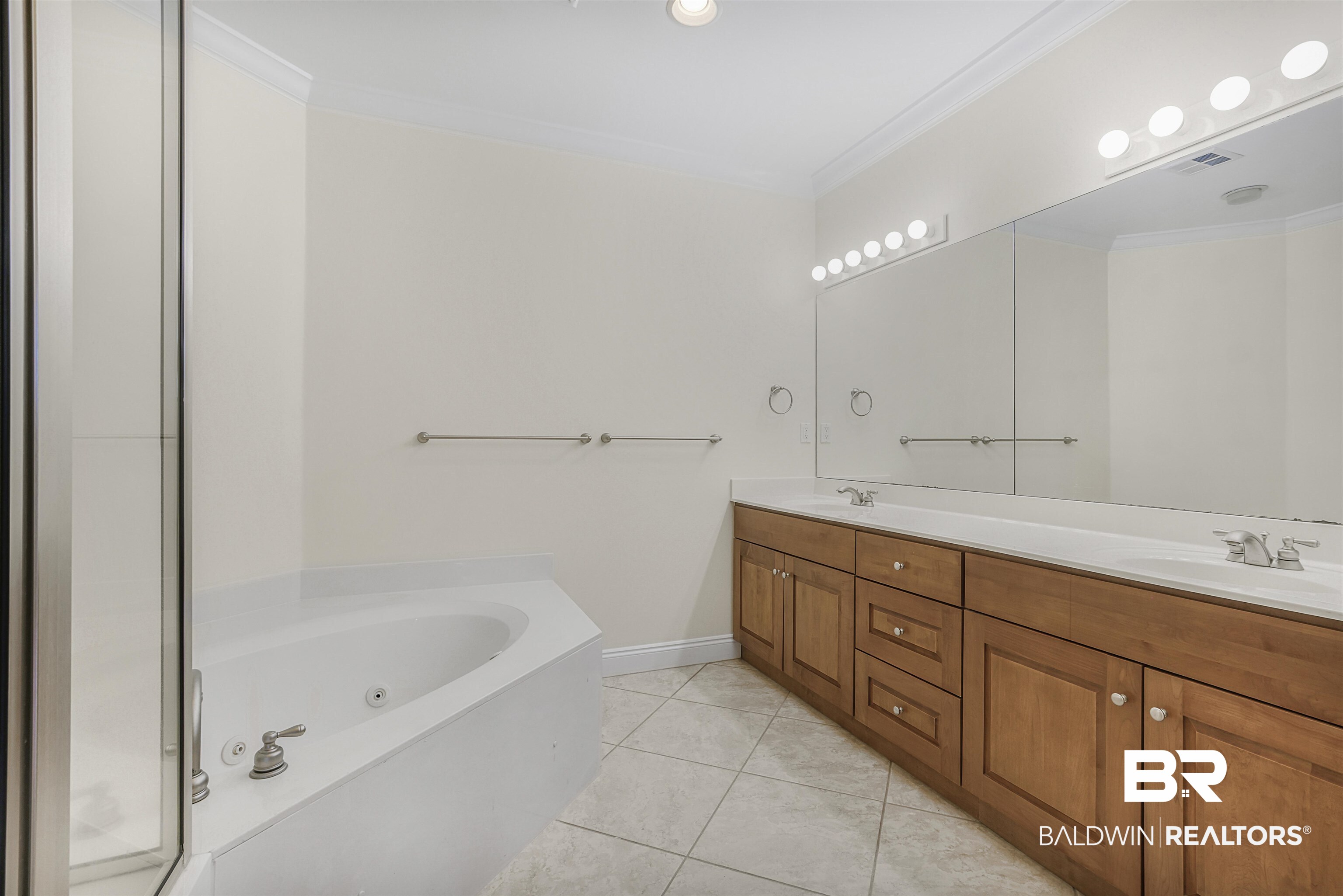 28250 Canal Road, Unit 106 Orange Beach, AL 36561 - Photo 15 of 50 Full bathroom featuring a jetted tub, double vanity, ornamental molding, light tile patterned floors, and a shower stall