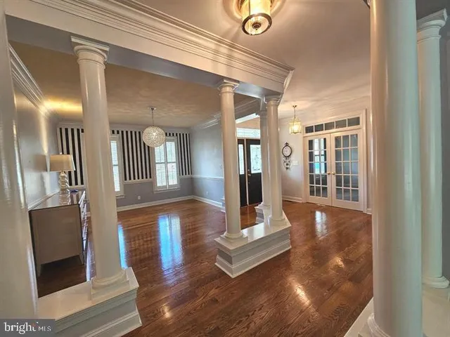 a view of a living room and dining room with wooden floor