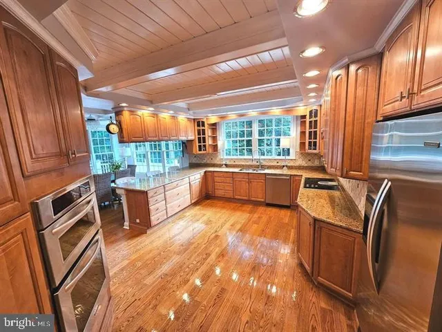 a kitchen with sink refrigerator and outdoor view