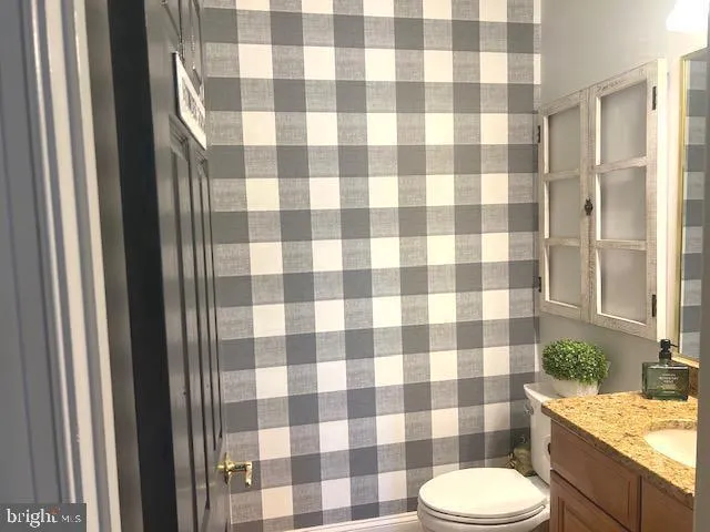 a bedroom with a bed and dresser with mirror