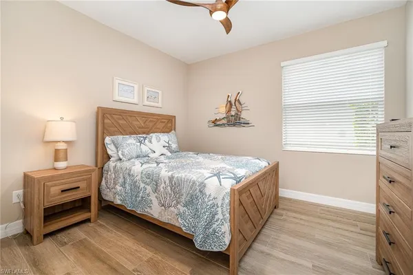 a bedroom with a bed and a night stand