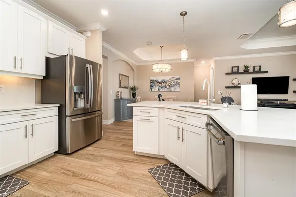 a kitchen with white cabinets and stainless steel appliances