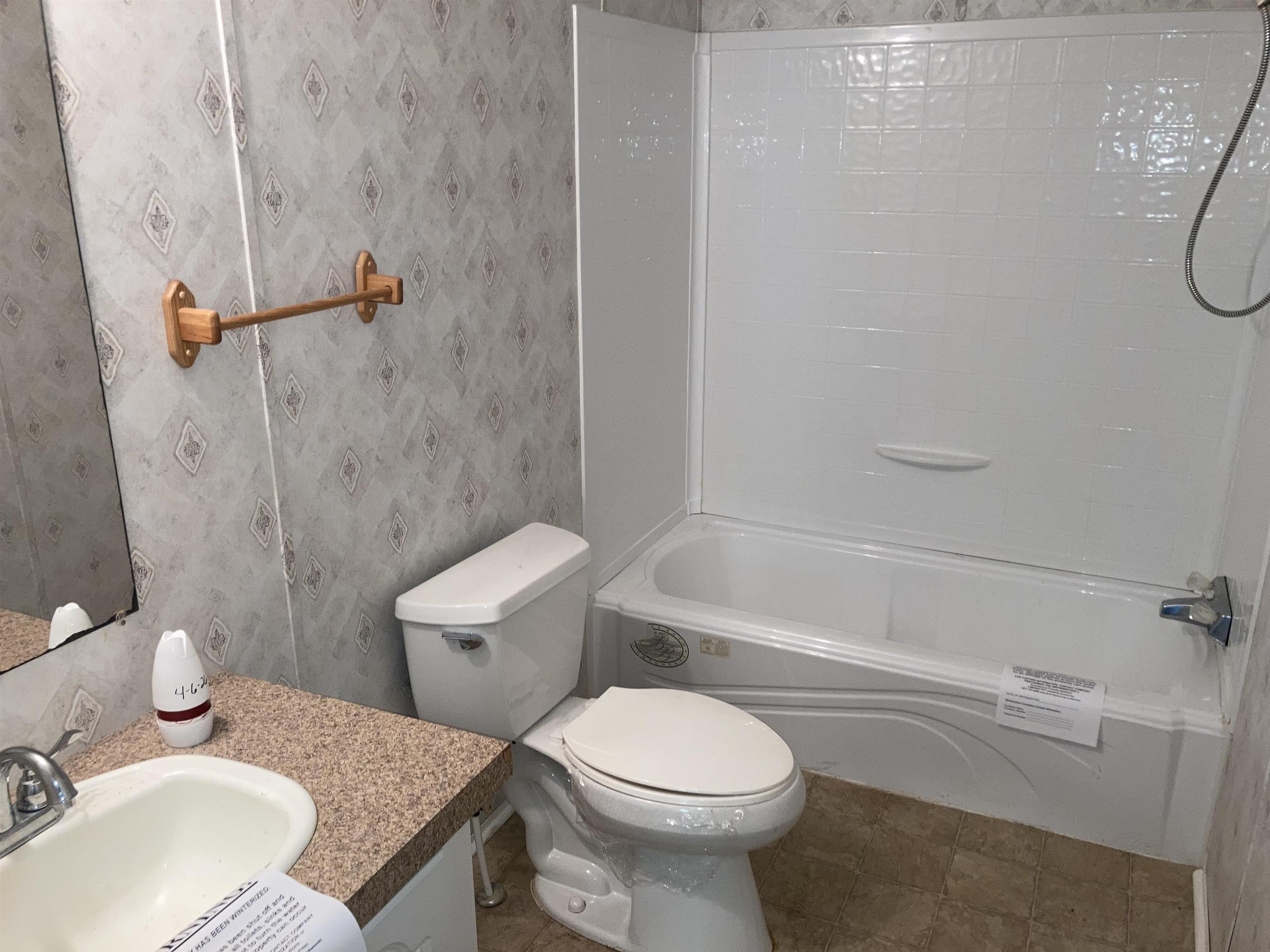 840 Rose Road Somerville, TN 38068 - Photo 18 of 21 Bathroom with vanity, wallpapered walls, and bathtub / shower combination