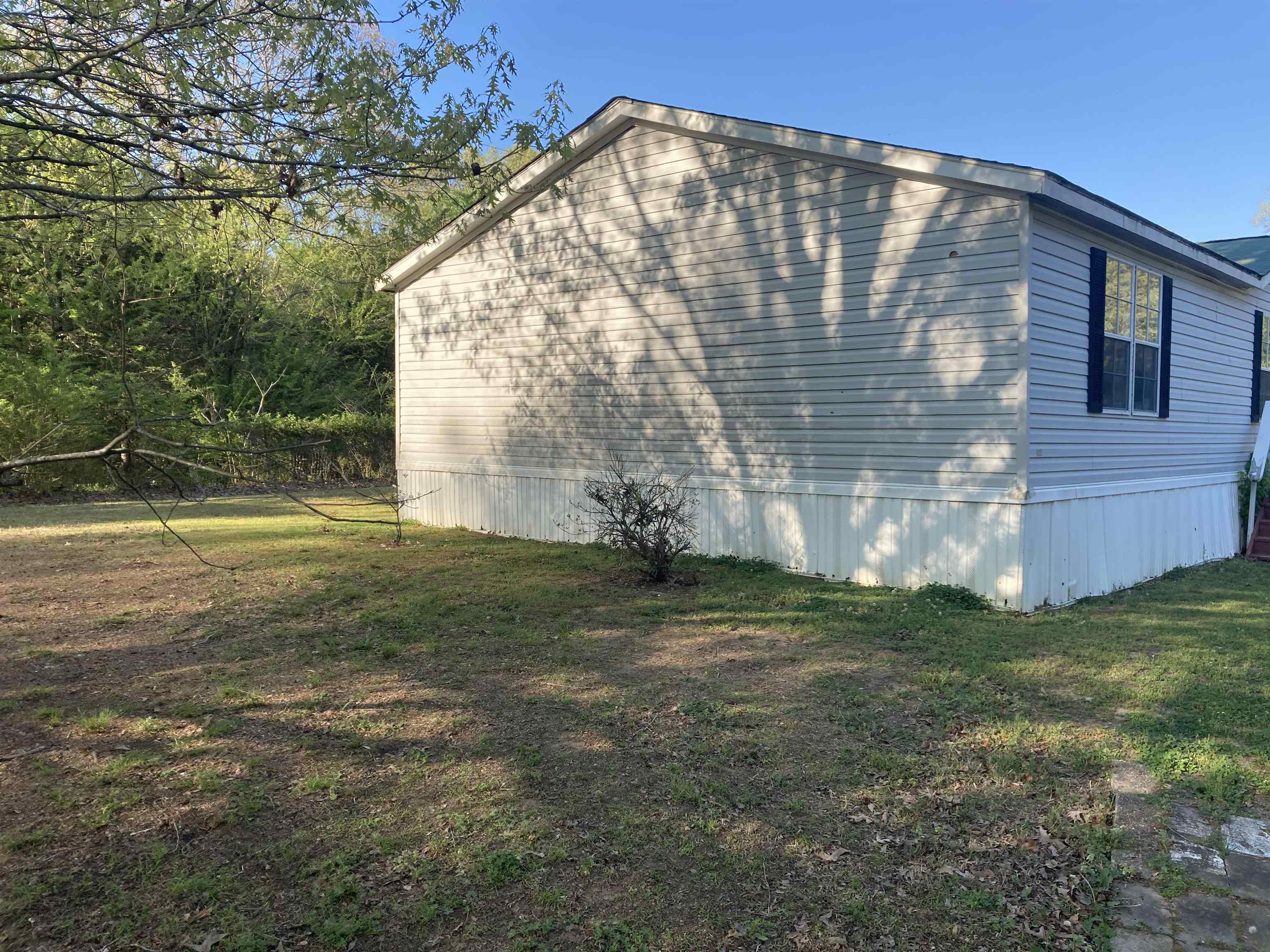 840 Rose Road Somerville, TN 38068 - Photo 3 of 21 View of side of property with a lawn