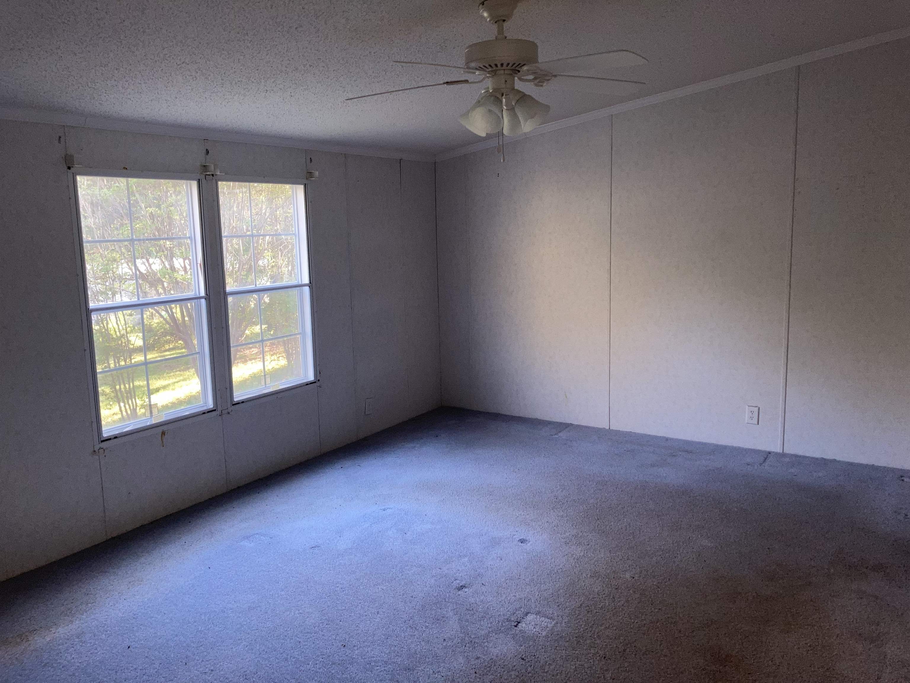 840 Rose Road Somerville, TN 38068 - Photo 4 of 21 Carpeted spare room with ceiling fan