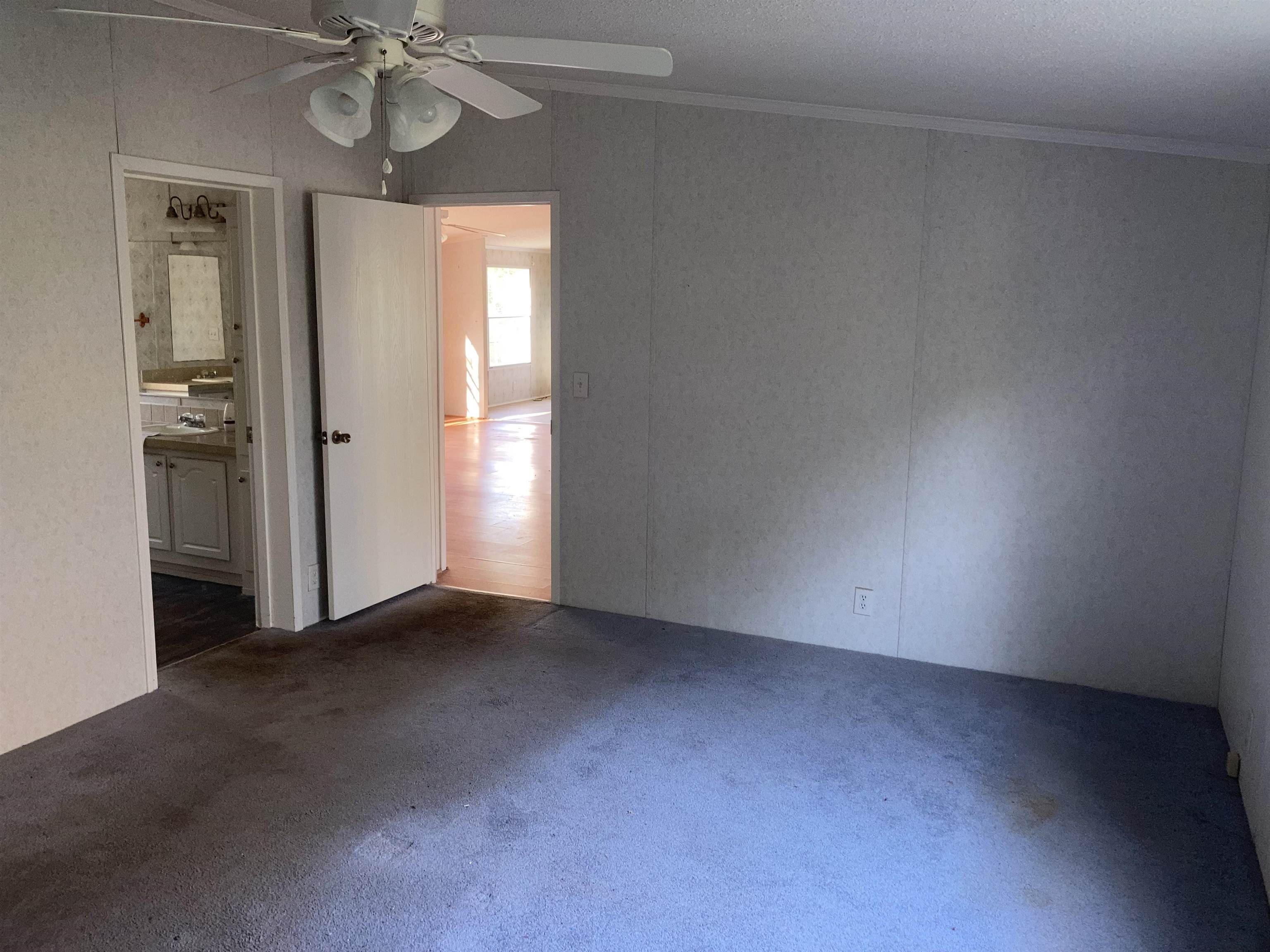 840 Rose Road Somerville, TN 38068 - Photo 8 of 21 Carpeted empty room with crown molding and ceiling fan