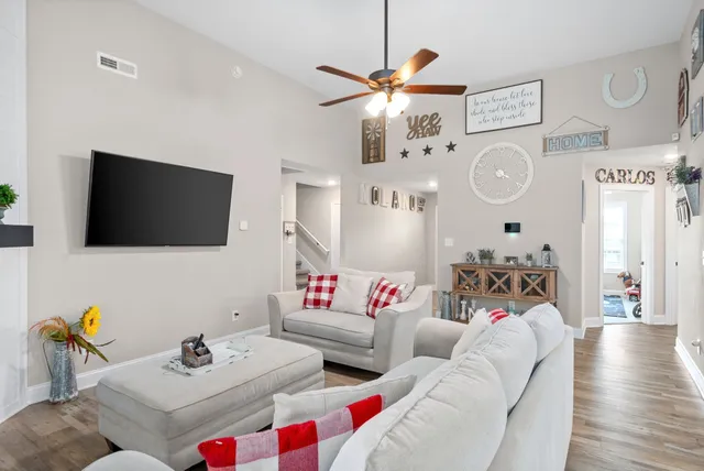a living room with furniture and a flat screen tv
