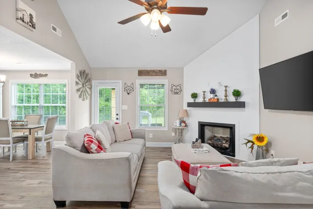 a living room with furniture and a fireplace