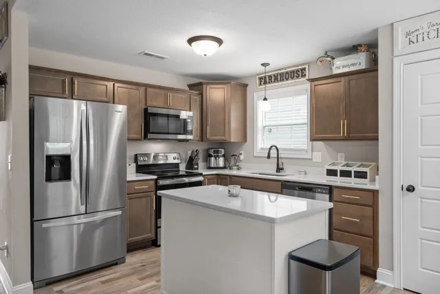 a kitchen with a sink appliances and cabinets