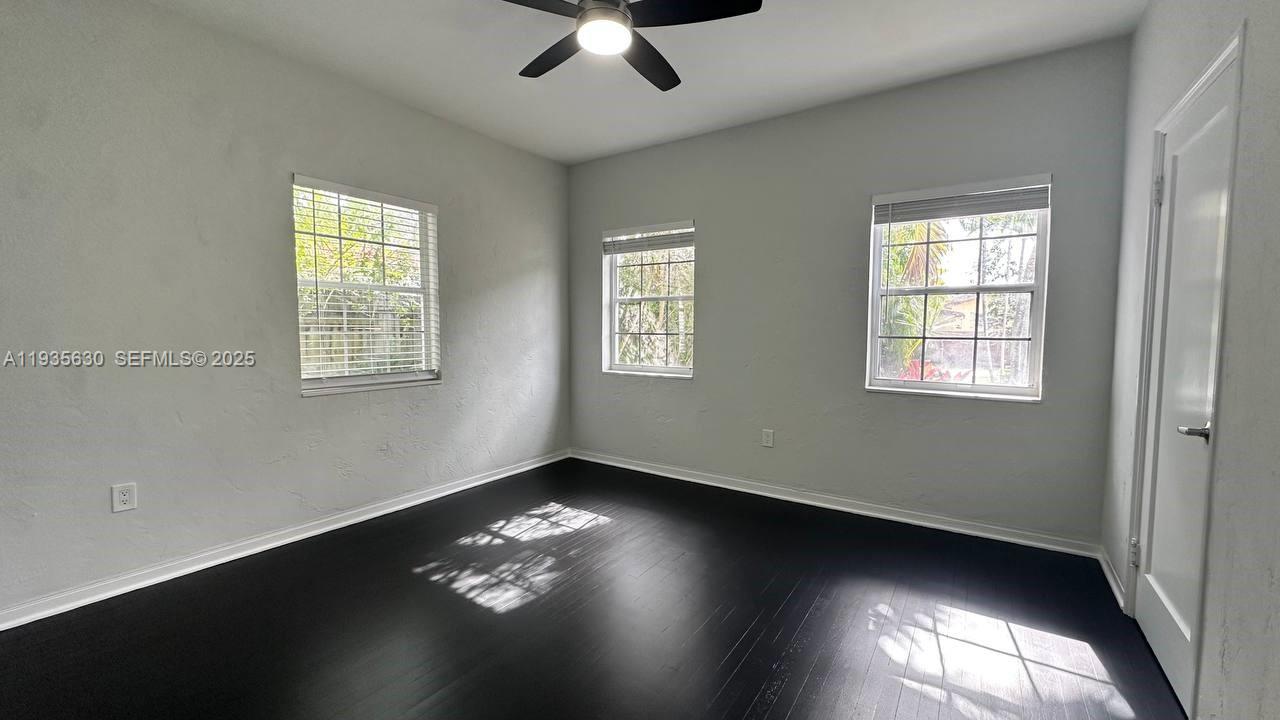 1824 Southwest 24th Street Miami, FL 33145 - Photo 14 of 35 a view of an empty room with wooden floor and a window