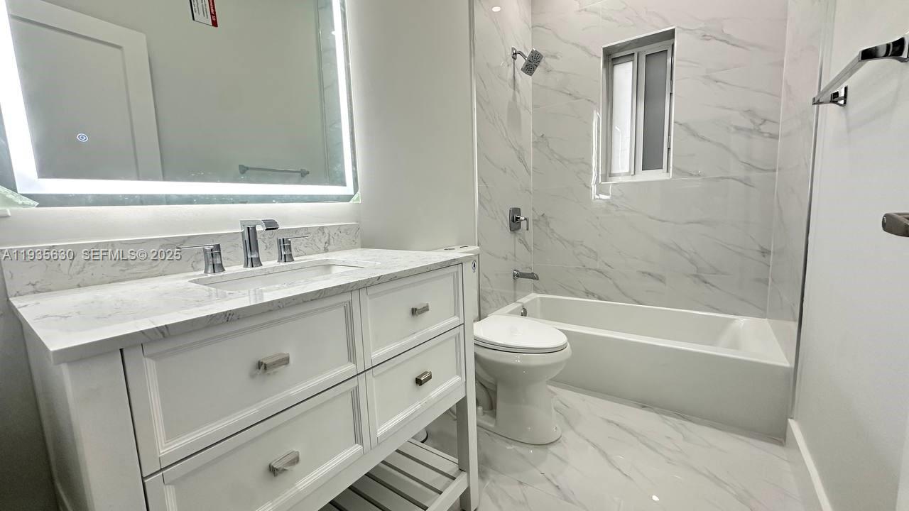 1824 Southwest 24th Street Miami, FL 33145 - Photo 16 of 35 a bathroom with a sink a toilet and bathtub