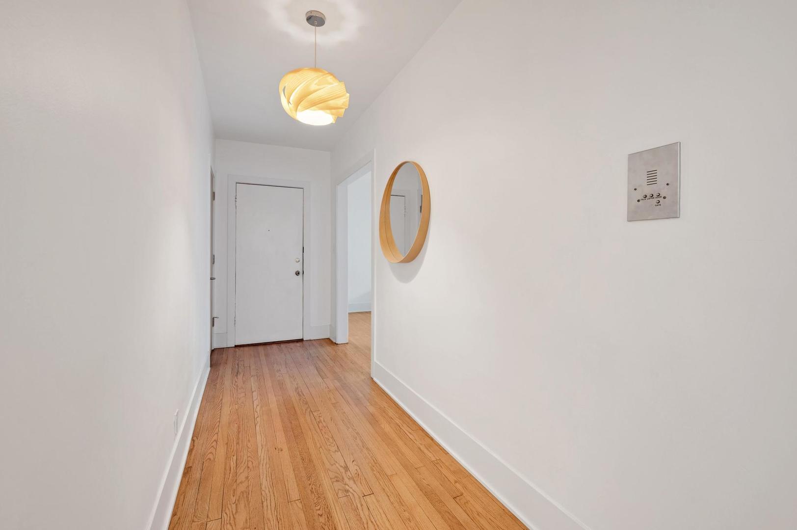 5469 South Ingleside Avenue, Unit 2N Chicago, IL 60615 - Photo 2 of 15 a view of a room with wooden floor and window