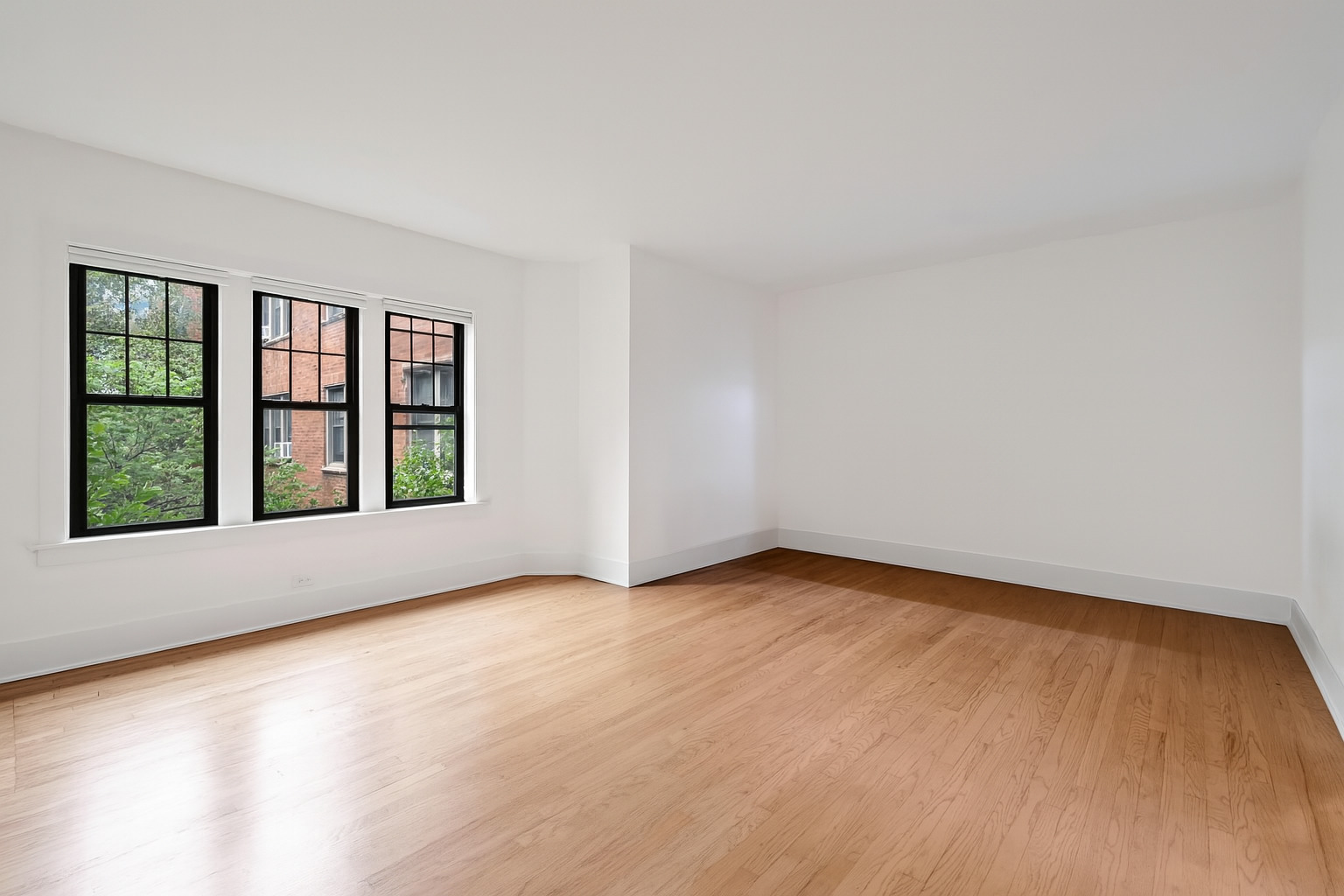 5469 South Ingleside Avenue, Unit 2N Chicago, IL 60615 - Photo 4 of 15 a view of an empty room with a window and wooden floor