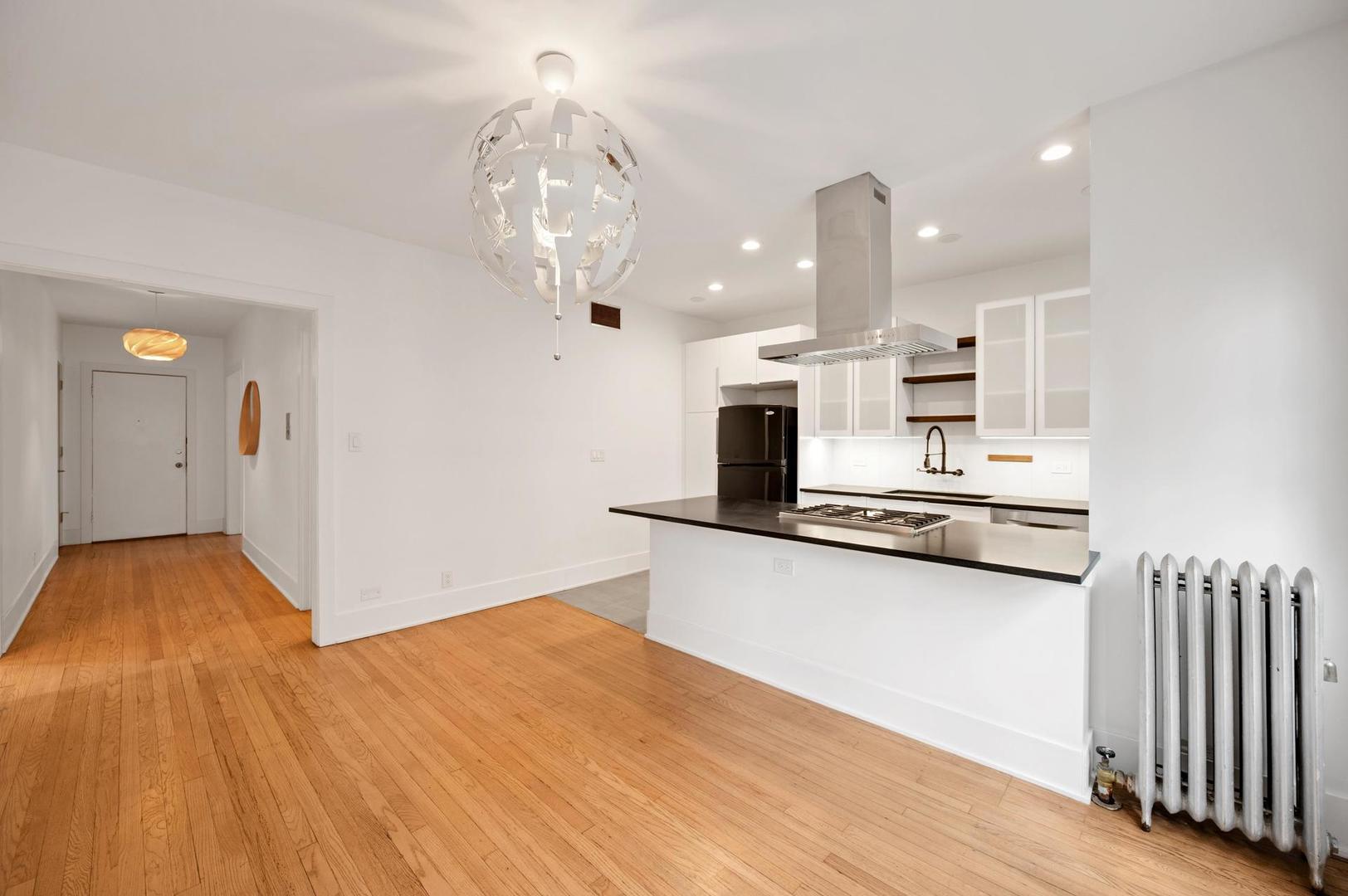 5469 South Ingleside Avenue, Unit 2N Chicago, IL 60615 - Photo 7 of 15 a kitchen with stainless steel appliances kitchen island granite countertop a refrigerator and a sink