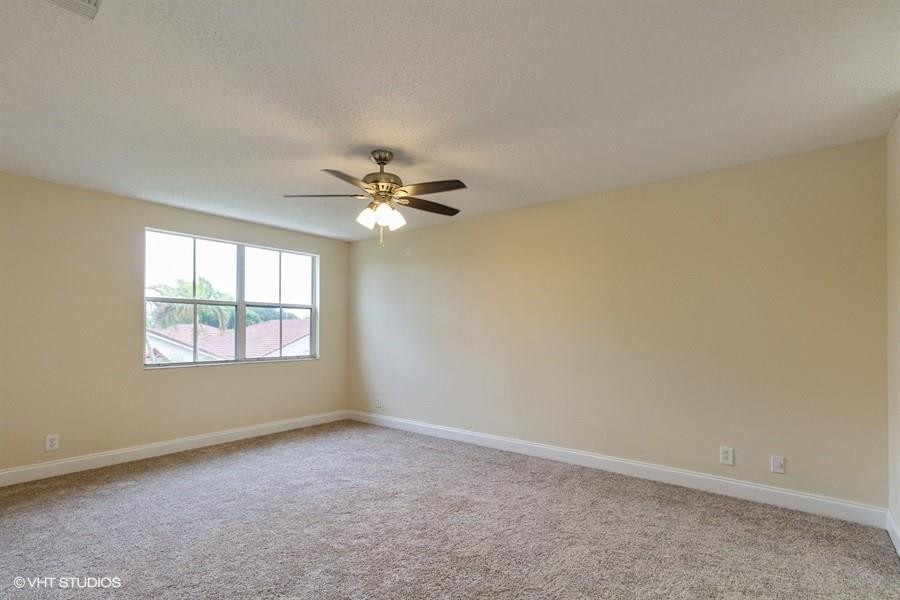 7463 Viscaya Circle Margate, FL 33063 - Photo 17 of 22 an empty room with windows and chandelier fan