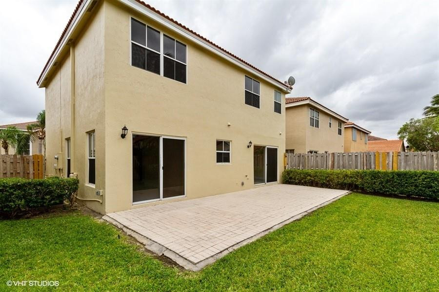 7463 Viscaya Circle Margate, FL 33063 - Photo 21 of 22 a front view of a house with garden