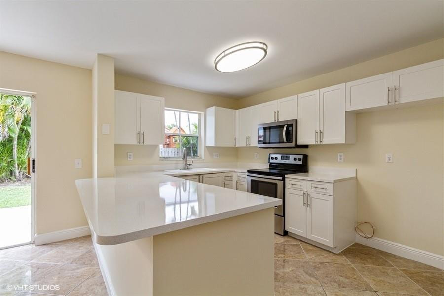 7463 Viscaya Circle Margate, FL 33063 - Photo 8 of 22 a kitchen with stainless steel appliances granite countertop a refrigerator a stove top oven a sink and dishwasher