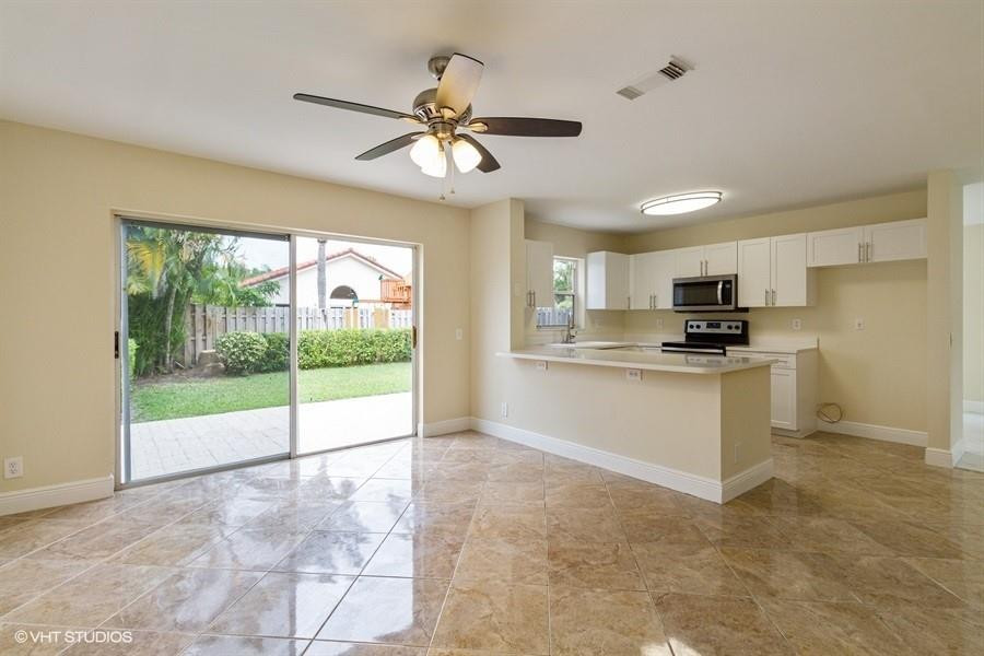 7463 Viscaya Circle Margate, FL 33063 - Photo 10 of 22 a view of kitchen with refrigerator stove and cabinets