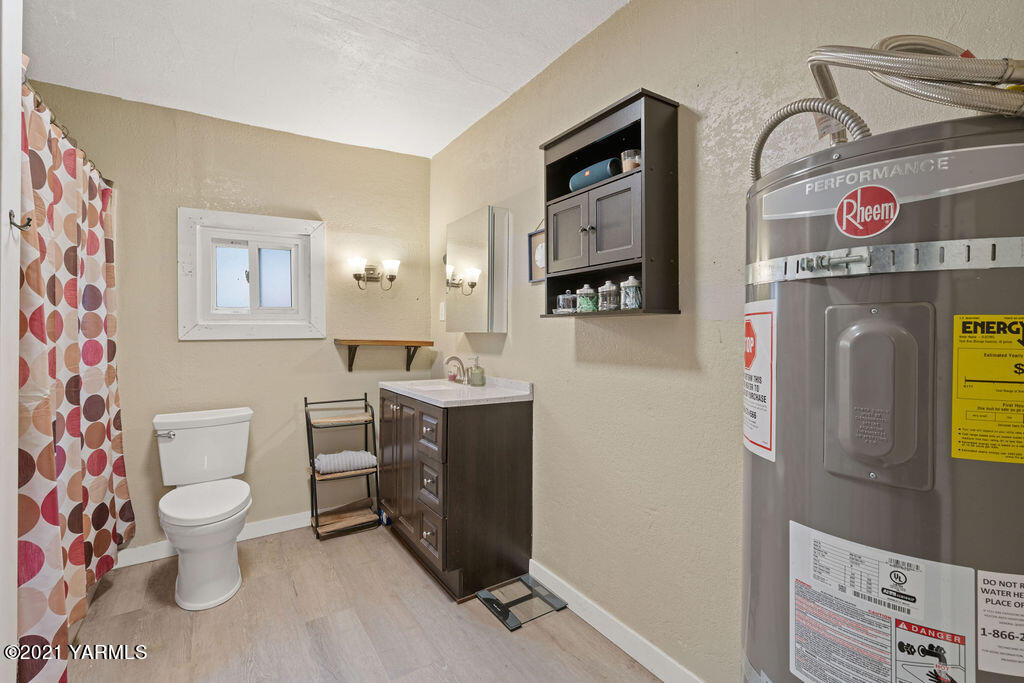 10710 Hughes Road Yakima, WA 98903 - Photo 9 of 21 a view of bathroom with a toilet sink and mirror