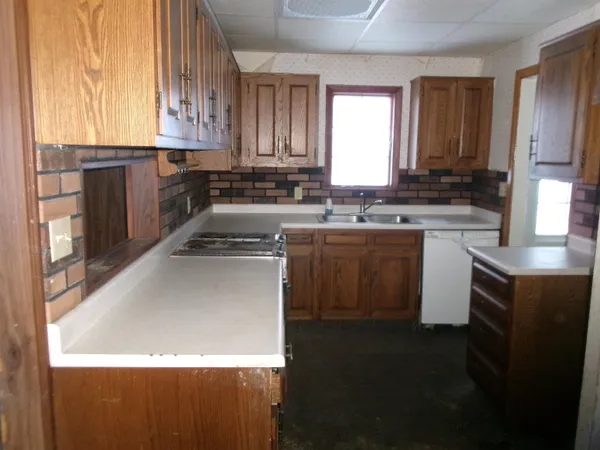 a kitchen with a sink stove and cabinets