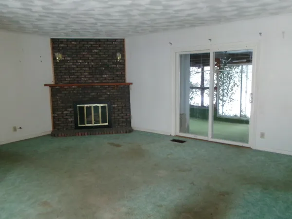 a view of an empty room with a fireplace
