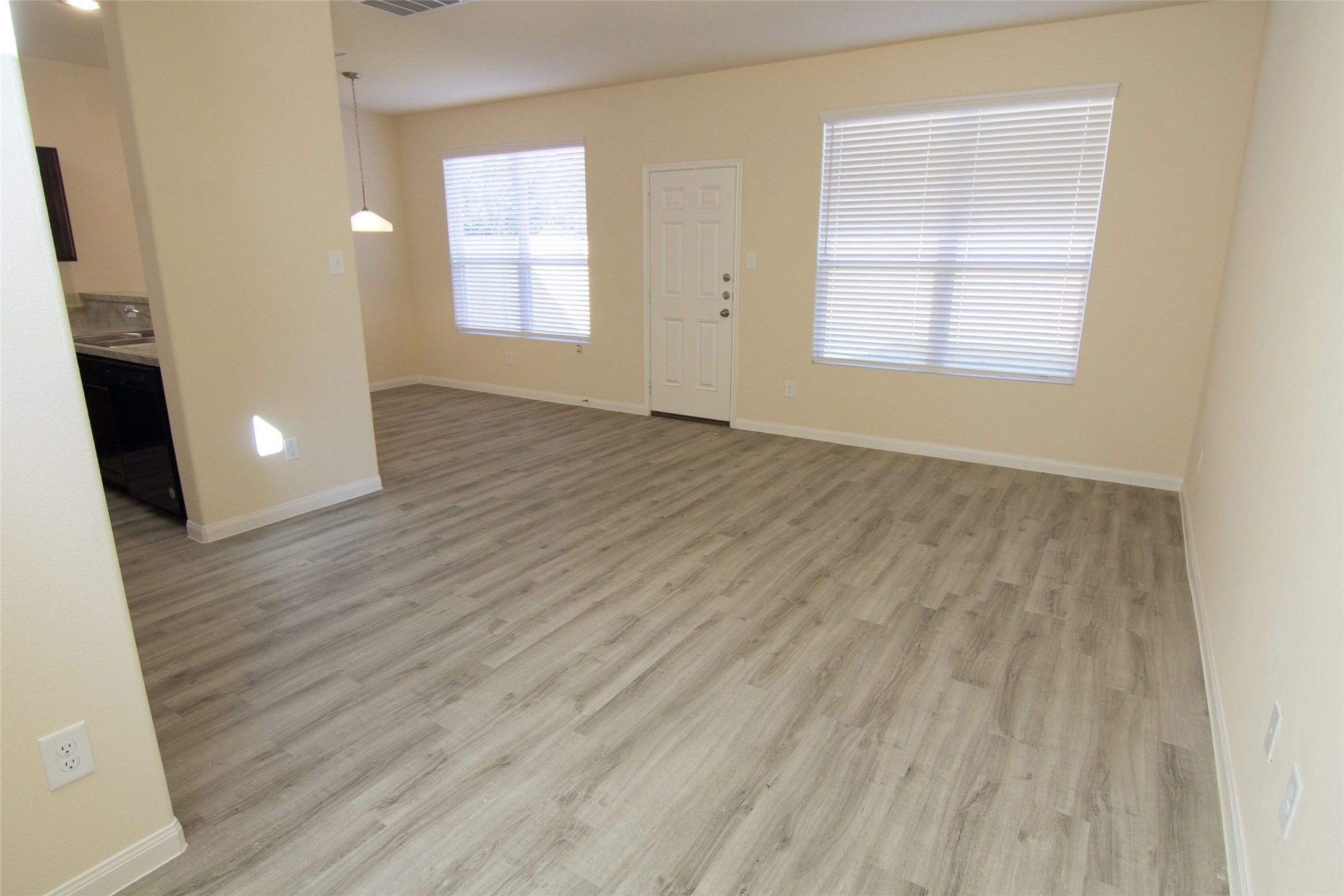 12723 Veterans Ranch Road Houston, TX 77014 - Photo 8 of 15 an empty room with wooden floor and windows