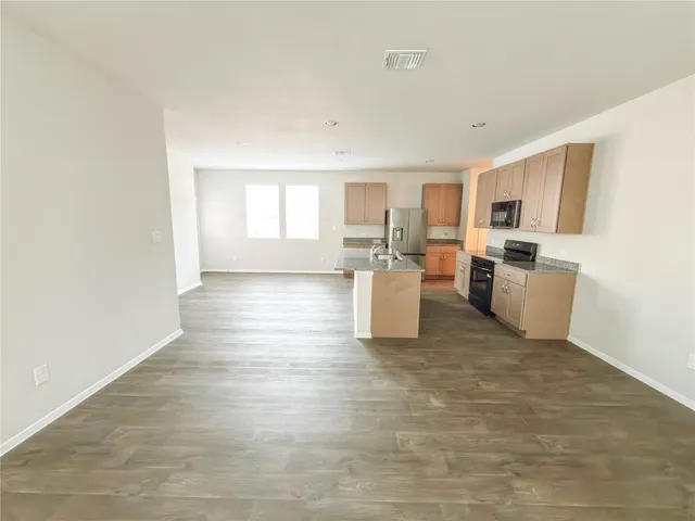 a view of a large pool with an outdoor space and seating area