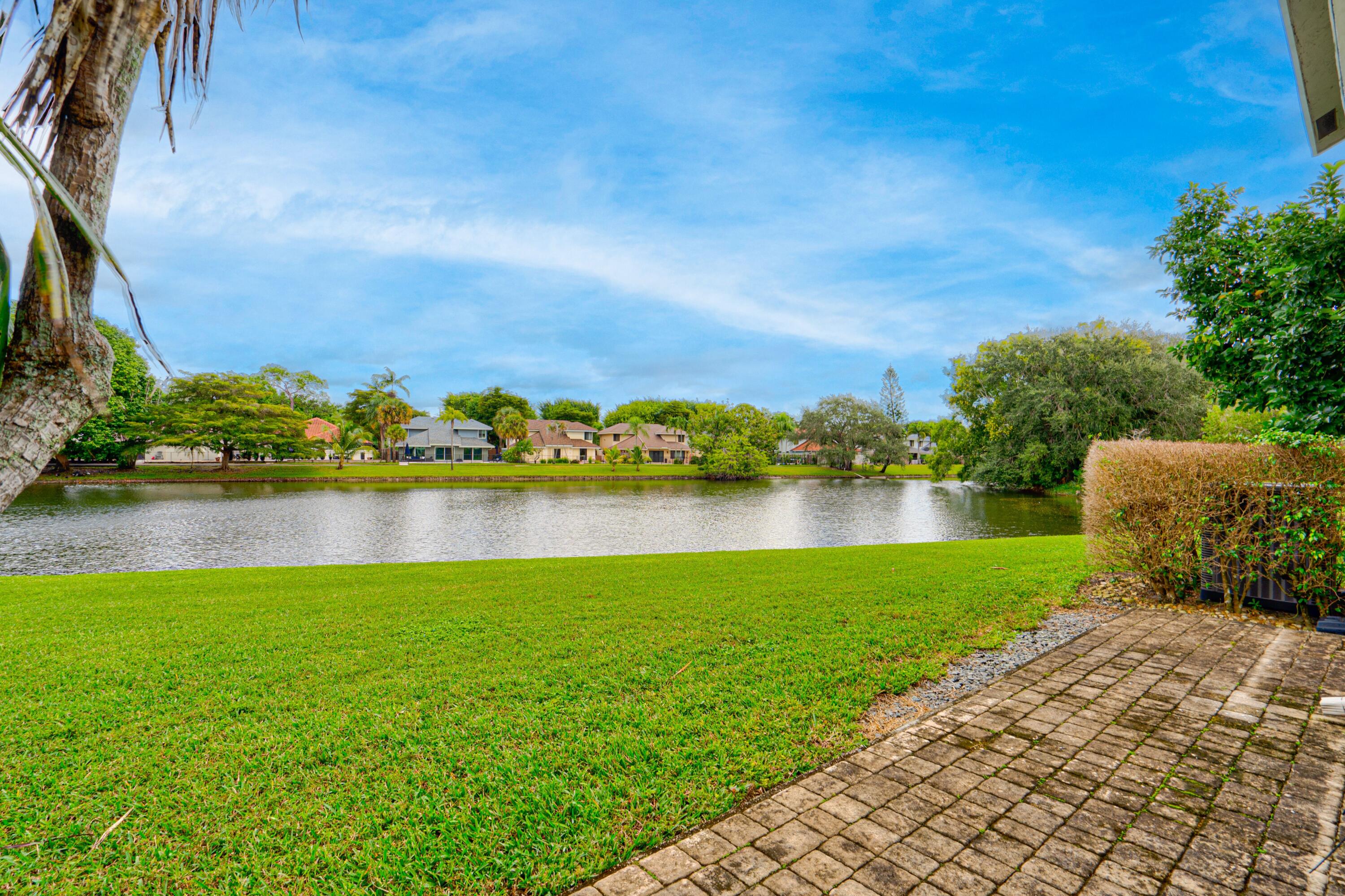 6663 Boca Pines Trail, Unit A Boca Raton, FL 33433 - Photo 18 of 60 a view of a lake with a big yard