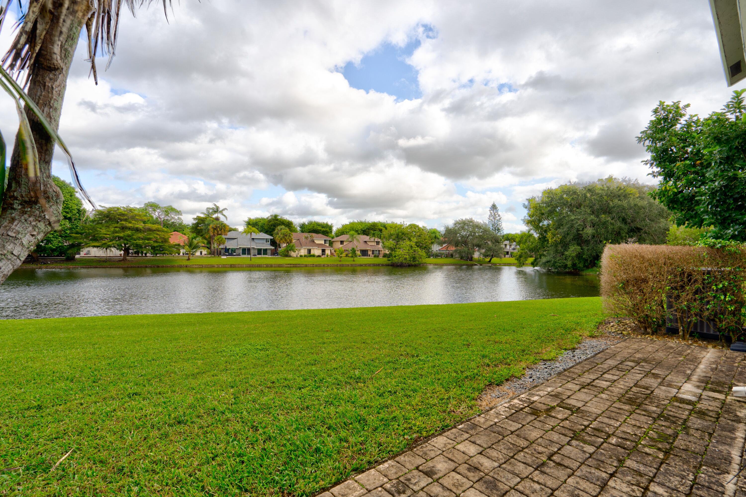 6663 Boca Pines Trail, Unit A Boca Raton, FL 33433 - Photo 19 of 60 a view of a lake with a big yard