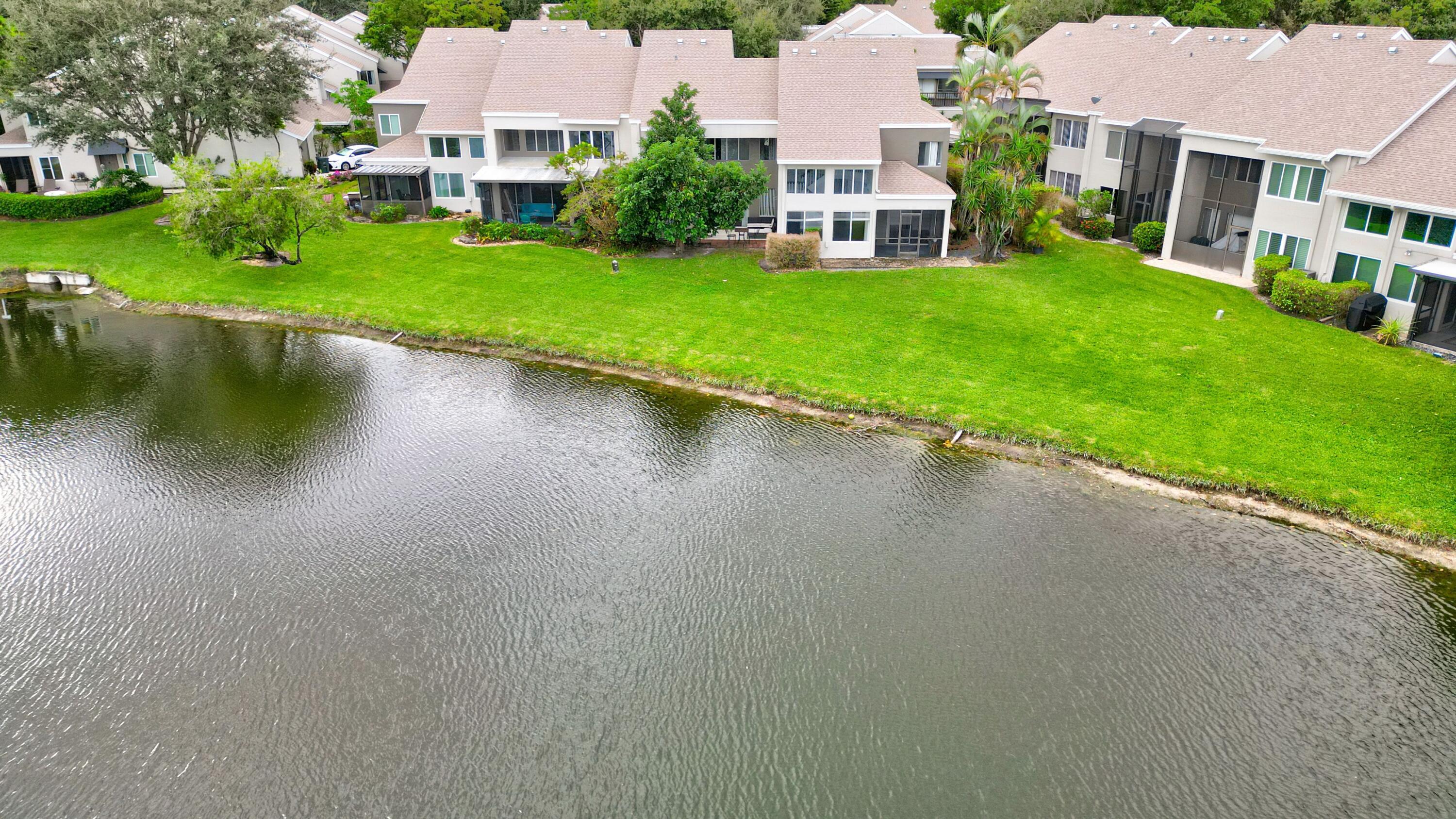 6663 Boca Pines Trail, Unit A Boca Raton, FL 33433 - Photo 21 of 60 a view of a lake with a house in the background