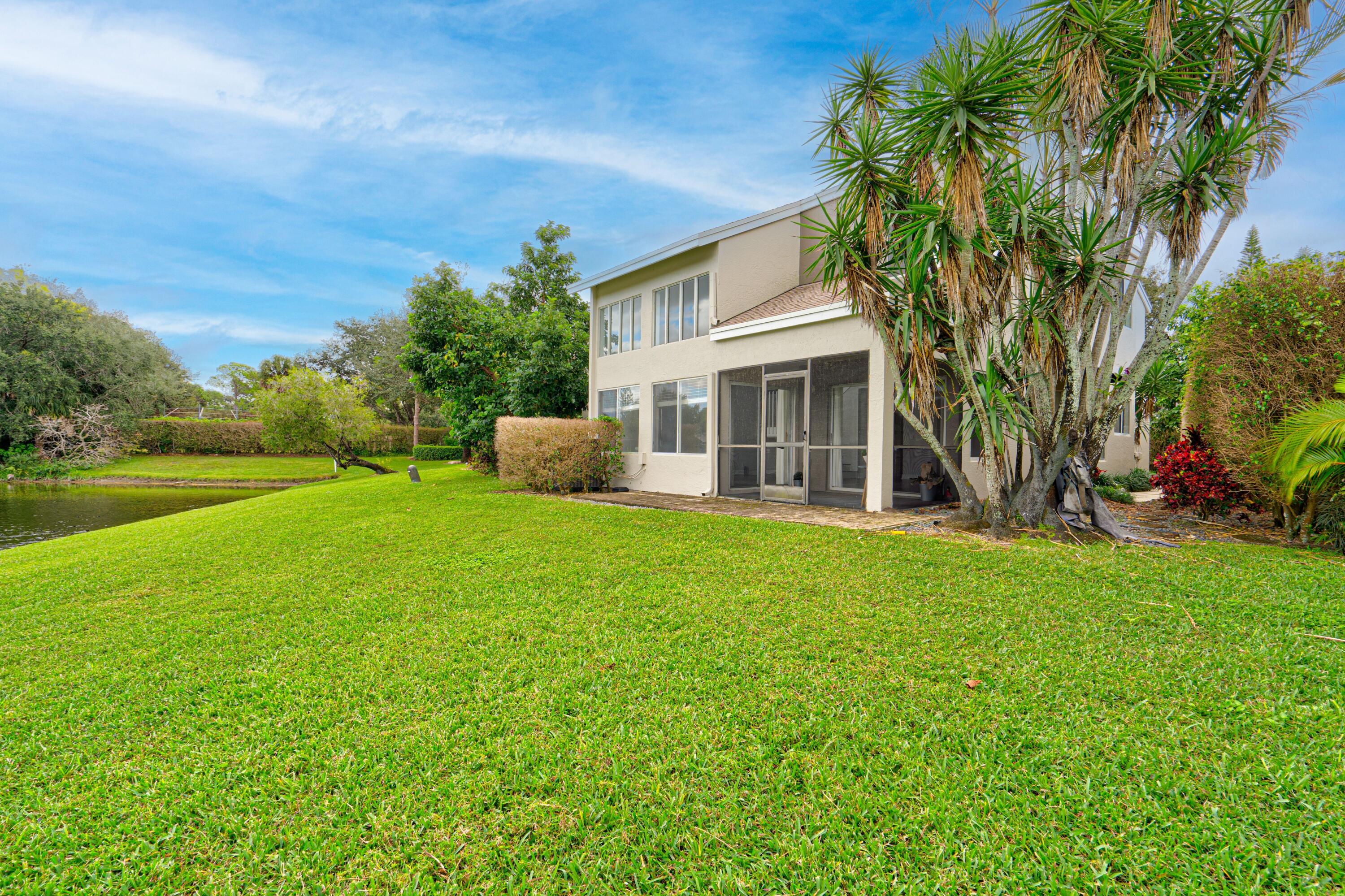 6663 Boca Pines Trail, Unit A Boca Raton, FL 33433 - Photo 22 of 60 a view of a house with backyard and a tree