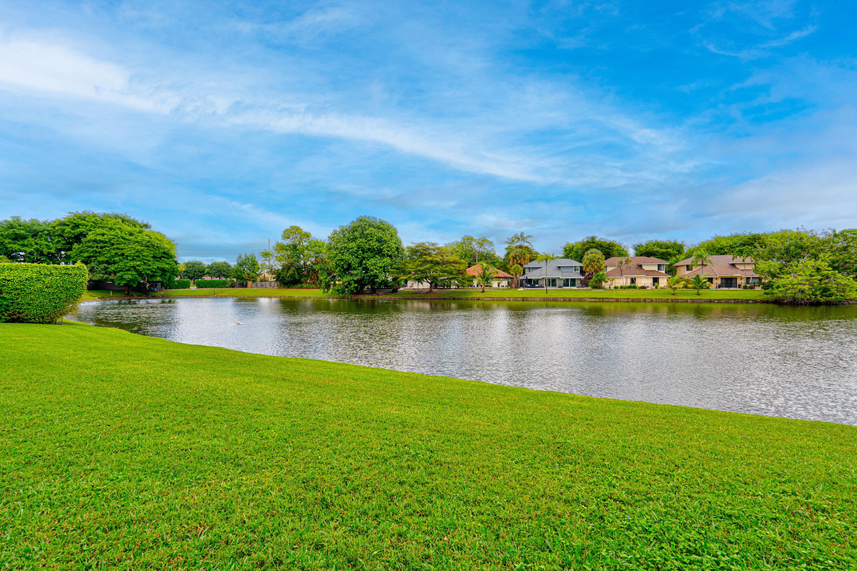 6663 Boca Pines Trail, Unit A Boca Raton, FL 33433 - Photo 23 of 60 a view of a lake with houses in the back