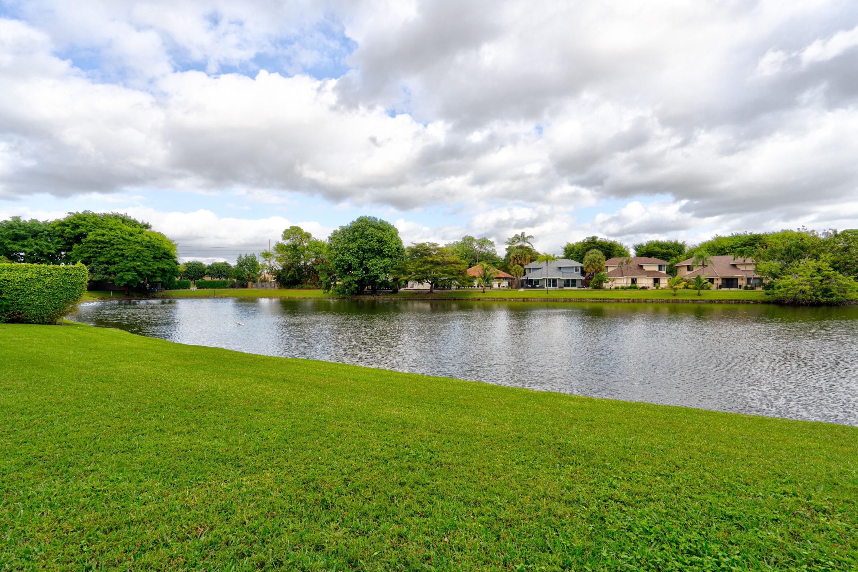6663 Boca Pines Trail, Unit A Boca Raton, FL 33433 - Photo 24 of 60 a view of a lake with houses in the back