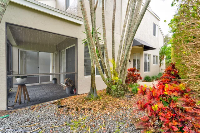 a view of an empty room with wooden floor and stairs