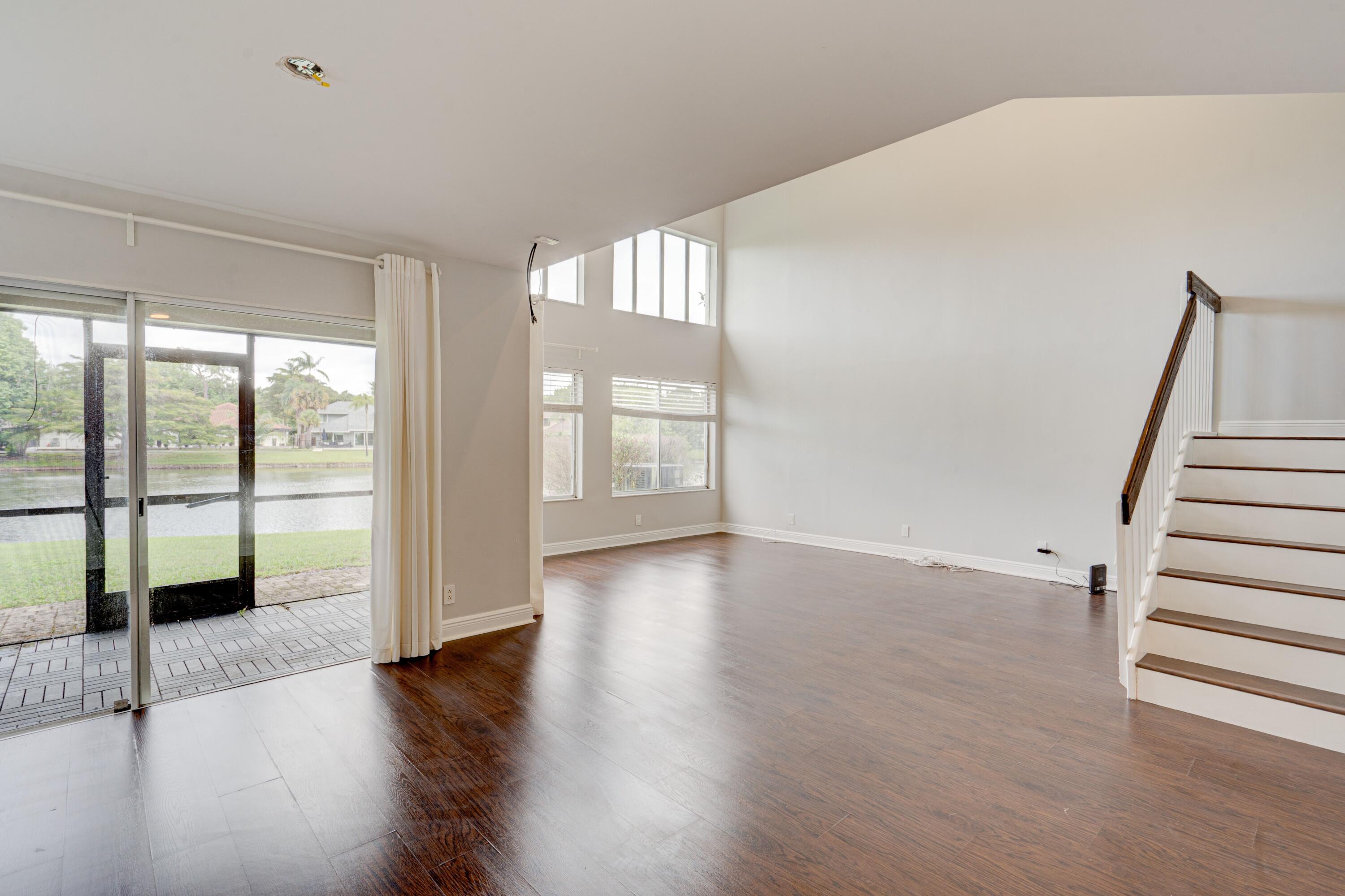 6663 Boca Pines Trail, Unit A Boca Raton, FL 33433 - Photo 26 of 60 a view of an empty room with wooden floor and a window