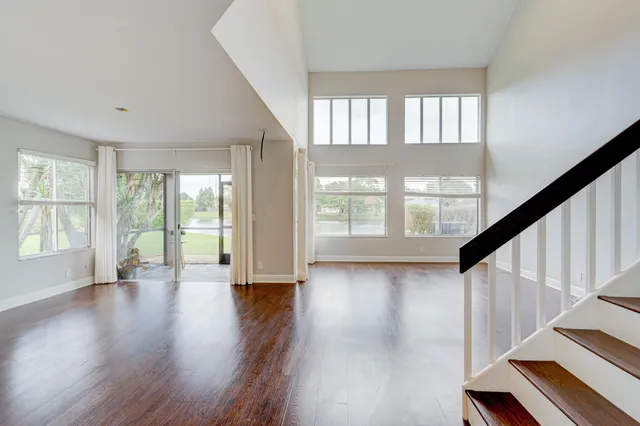 a view of a room with wooden floor and furniture
