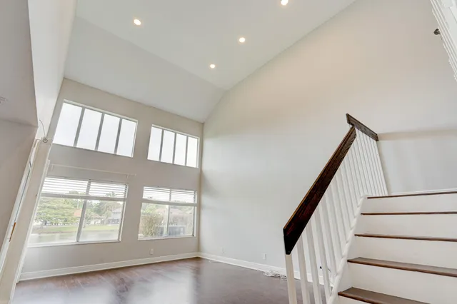a view of a kitchen with wooden floor and electronic appliances