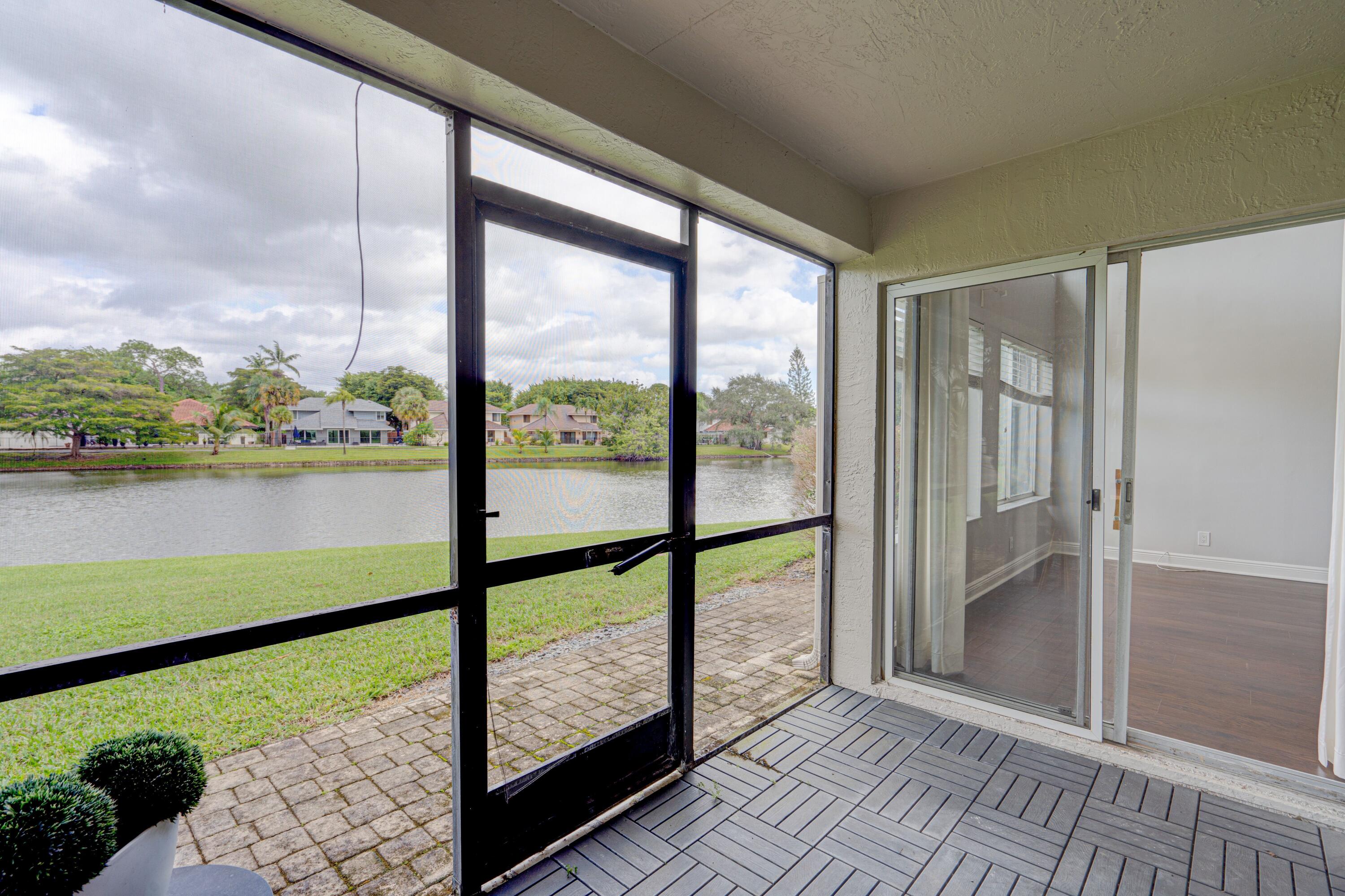 6663 Boca Pines Trail, Unit A Boca Raton, FL 33433 - Photo 35 of 60 a view of a room with wooden floor and lake view