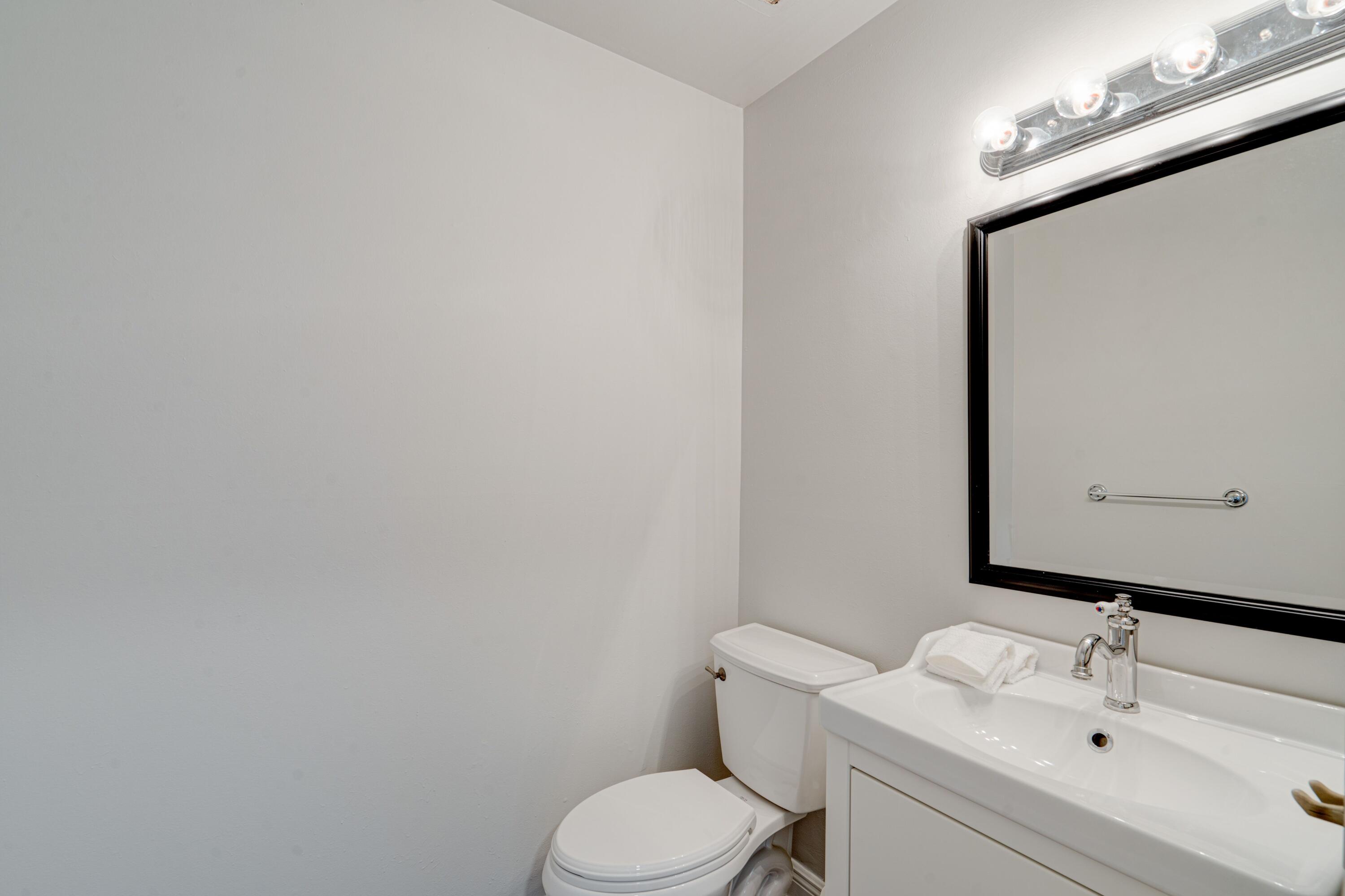 6663 Boca Pines Trail, Unit A Boca Raton, FL 33433 - Photo 42 of 60 a bathroom with a toilet sink vanity and mirror