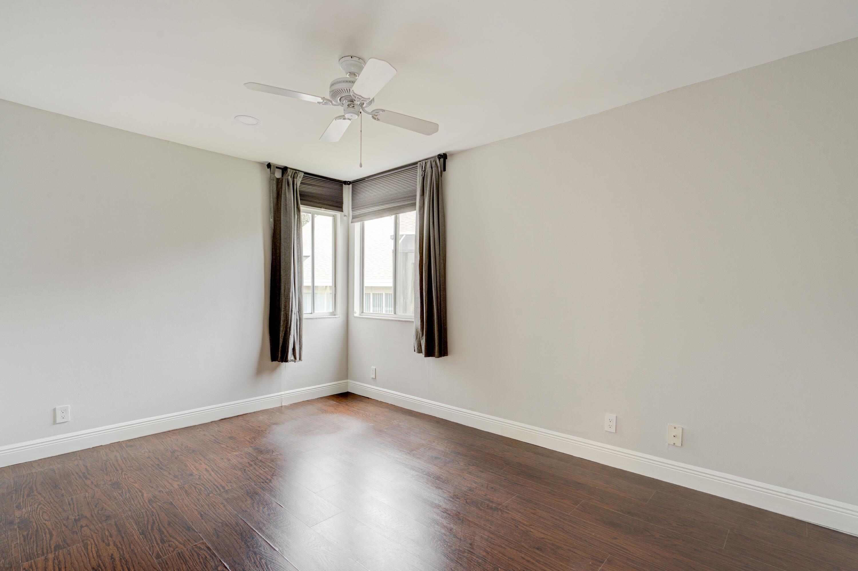 6663 Boca Pines Trail, Unit A Boca Raton, FL 33433 - Photo 48 of 60 an empty room with wooden floor and ceiling fan