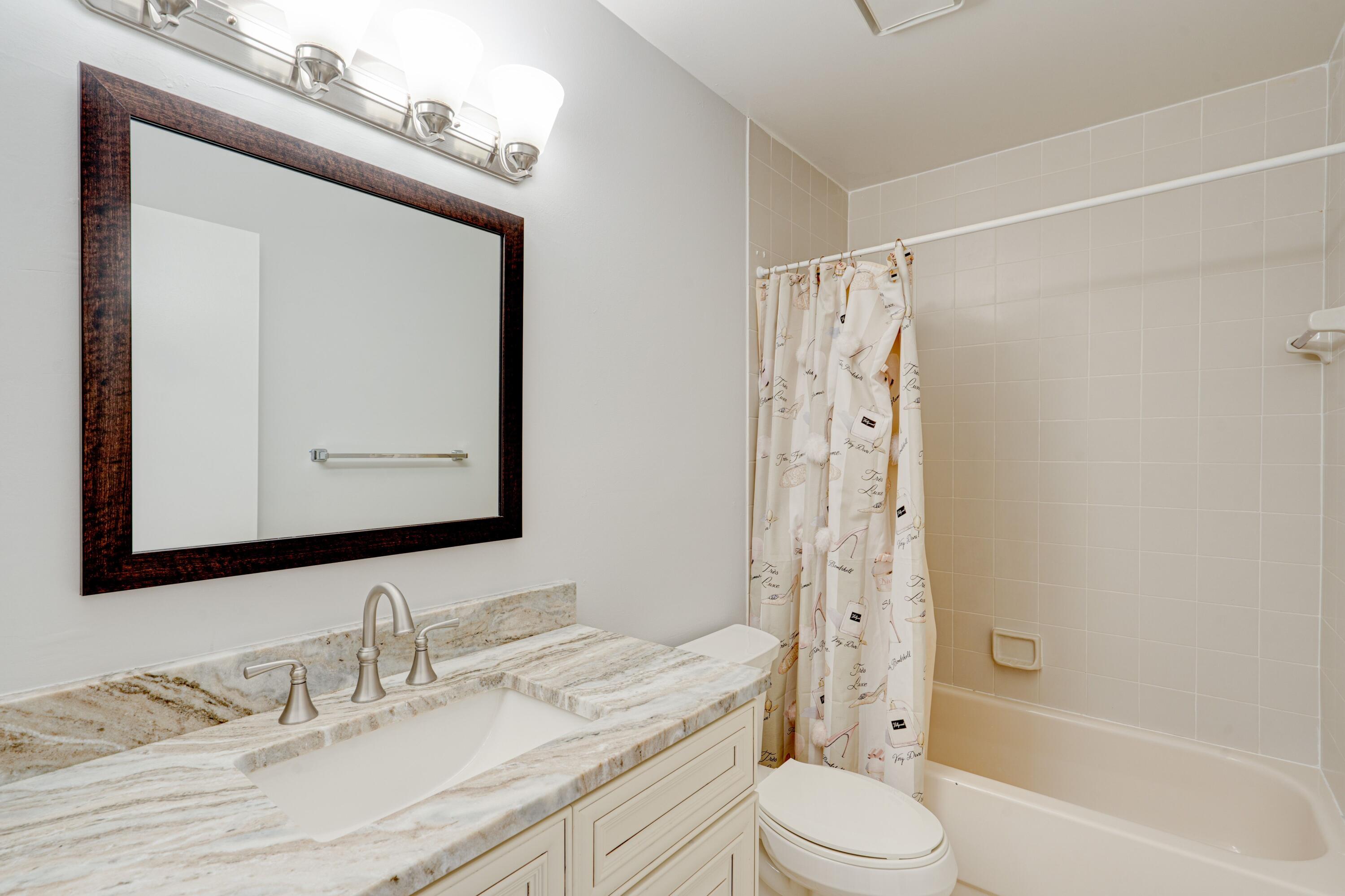 6663 Boca Pines Trail, Unit A Boca Raton, FL 33433 - Photo 50 of 60 a bathroom with a granite countertop sink toilet mirror and shower