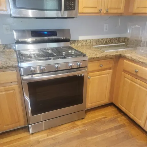 a stove top oven sitting inside of a kitchen