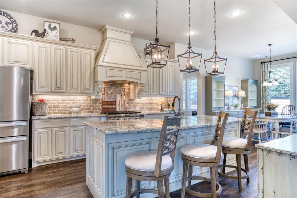 7760 Hackamore Street Frisco, TX 75036 - Photo 10 of 40 Upgraded granite counters, beautiful cabinetry & under-cabinet lighting