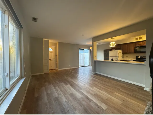 a view of a kitchen with wooden floor and a kitchen